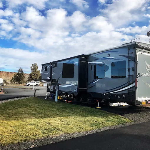 RV sites at golden hour with canyon wall behind them, Copper Ridge RV Resort