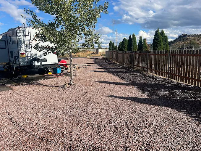 RV with awning out on paved site at Copper Ridge RV Resort
